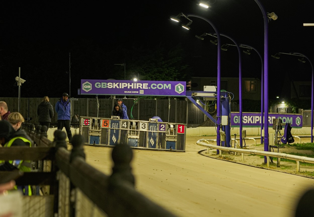 GB Skip Hire sponsorship banner at a greyhound racing track