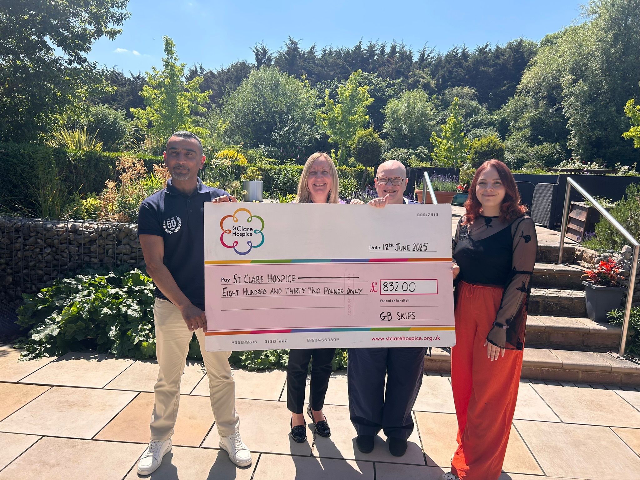 GB Skips presenting £832 charity cheque to St Clare Hospice