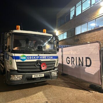GB Skip Hire Lorry And Grind Coffee Van Parked Outside Venue At Night